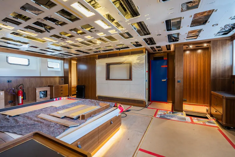 Valeria Yacht Photos Pics 1975 Feadship Motoryacht interior under renovation with wood paneling and modern lighting.