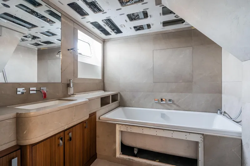 Valeria Yacht Photos Pics Luxurious bathroom in a 1975 Feadship motoryacht with modern fixtures and wooden cabinetry.