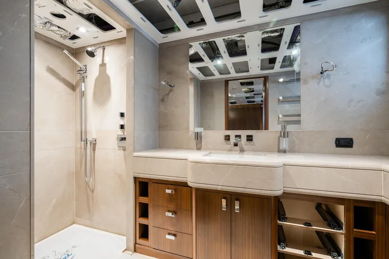 Valeria Yacht Photos Pics Luxurious bathroom interior of a 1975 Feadship Motoryacht with modern fixtures and wooden cabinetry.
