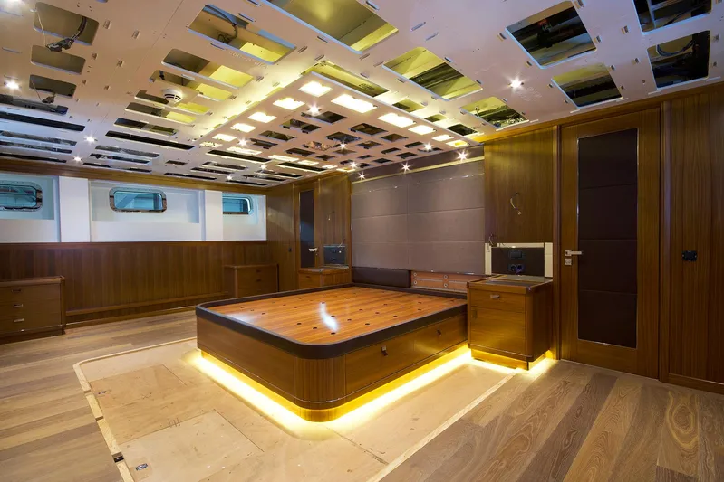 Valeria Yacht Photos Pics Luxurious 1975 Feadship motoryacht interior with modern wood paneling and ambient lighting.