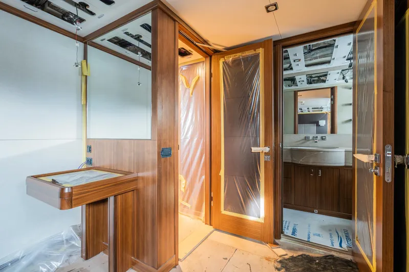 Valeria Yacht Photos Pics Interior of a 1975 Feadship Motoryacht under renovation, featuring wood paneling and modern fixtures.