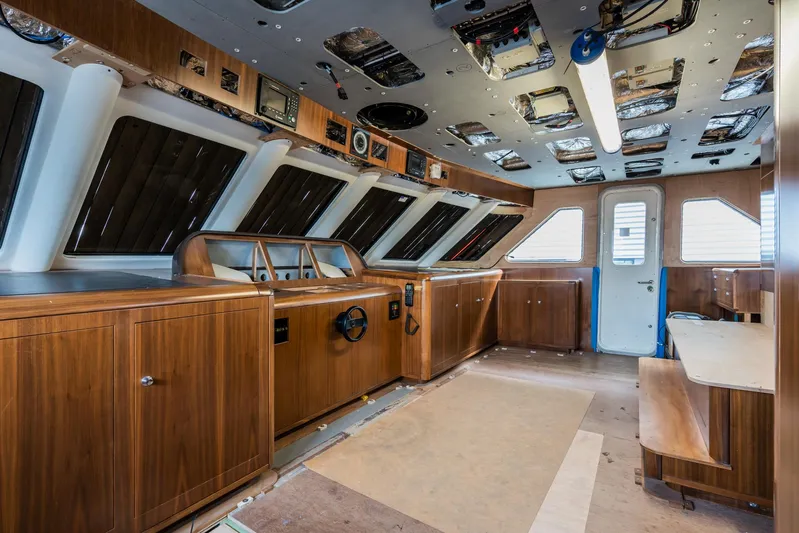 Valeria Yacht Photos Pics 1975 Feadship motoryacht interior with wooden paneling and large windows.