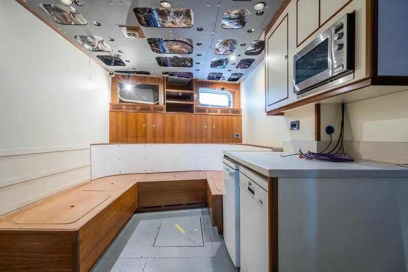 Valeria Yacht Photos Pics Interior of a 1975 Feadship Motoryacht with modern kitchen and seating area.