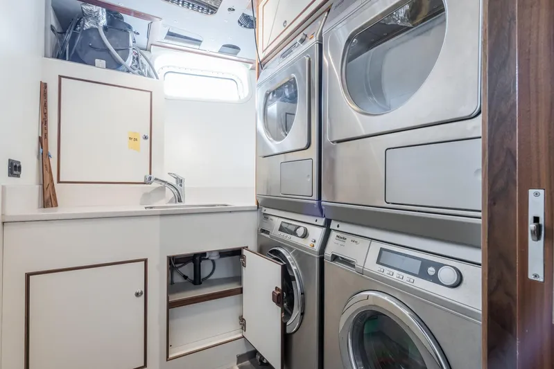 Valeria Yacht Photos Pics Laundry room on 1975 Feadship Motoryacht with stacked washers and dryers.