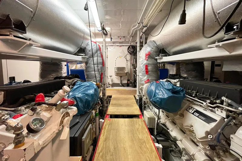 Valeria Yacht Photos Pics Engine room of a 1975 Feadship Motoryacht, featuring dual engines and maintenance equipment.