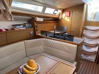 Beckon Yacht Photos Pics Interior of 2010 Jeanneau Sun Odyssey 39i Performance yacht with cozy seating and kitchen area.