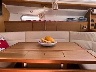 Beckon Yacht Photos Pics Interior of 2010 Jeanneau Sun Odyssey 39i Performance yacht with dining table and fruit bowl.