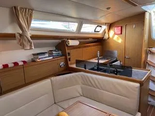 Beckon Yacht Photos Pics Interior of 2010 Jeanneau Sun Odyssey 39i Performance yacht, featuring cozy seating and modern kitchen.