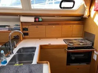 Beckon Yacht Photos Pics Interior of 2010 Jeanneau Sun Odyssey 39i Performance yacht kitchen with sink and stove.