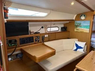 Beckon Yacht Photos Pics Interior of 2010 Jeanneau Sun Odyssey 39i Performance yacht with cozy seating and navigation equipment.
