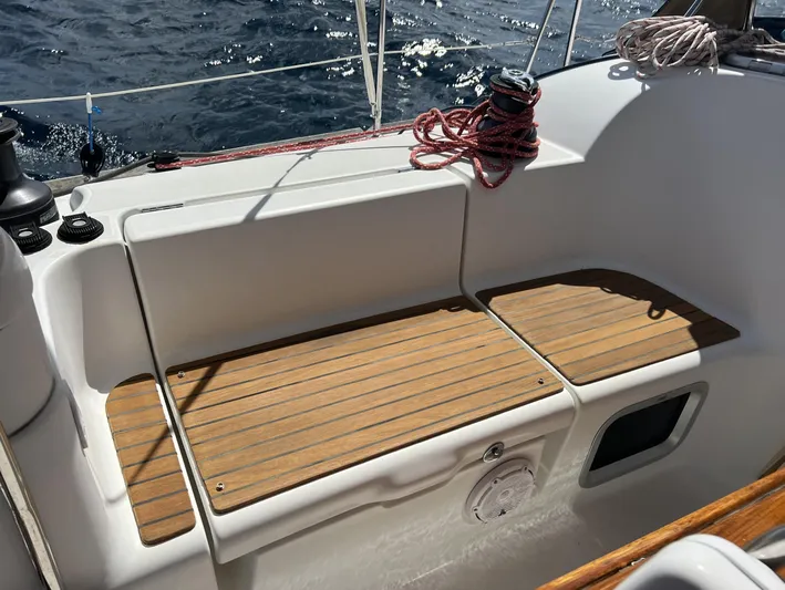 Beckon Yacht Photos Pics Cockpit of 2010 Jeanneau Sun Odyssey 39i Performance sailboat with teak seating and ocean view.