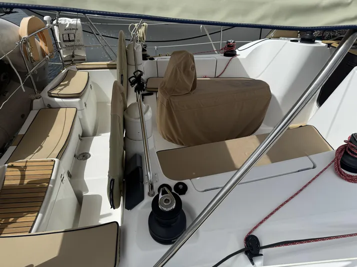 Beckon Yacht Photos Pics 2010 Jeanneau Sun Odyssey 39i Performance sailboat cockpit with beige seating and covered helm.