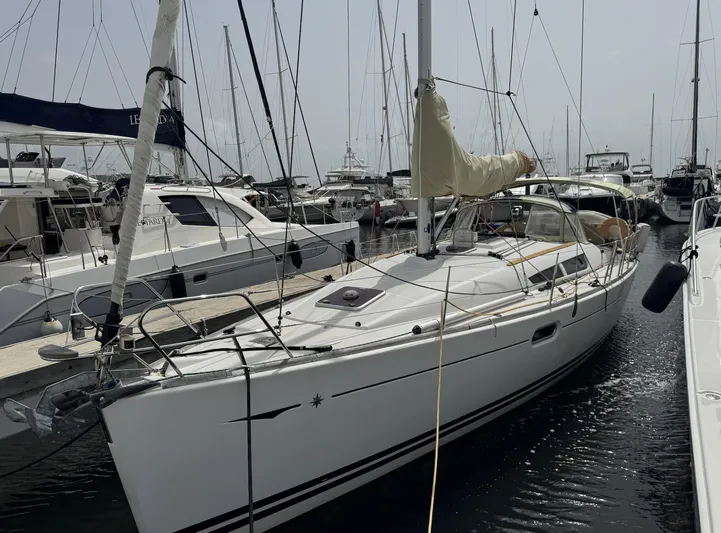 Beckon Yacht Photos Pics 2010 Jeanneau Sun Odyssey 39i Performance sailboat docked in a marina.