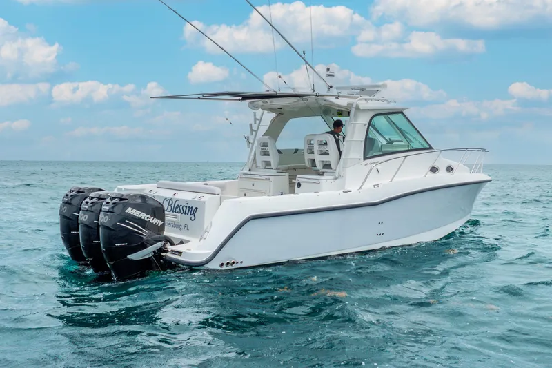 Reel Blessing Yacht Photos Pics 2012 Boston Whaler 345 Conquest boat on open water, featuring triple Mercury engines.