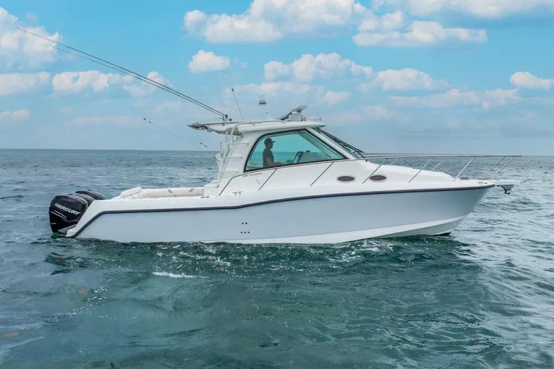 Reel Blessing Yacht Photos Pics 2012 Boston Whaler 345 Conquest boat cruising on open water under a blue sky.