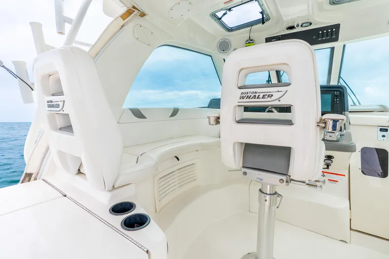 Reel Blessing Yacht Photos Pics Interior of 2012 Boston Whaler 345 Conquest boat with seating and control panel.