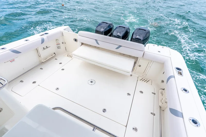 Reel Blessing Yacht Photos Pics 2012 Boston Whaler 345 Conquest boat deck with triple outboard motors on the ocean.