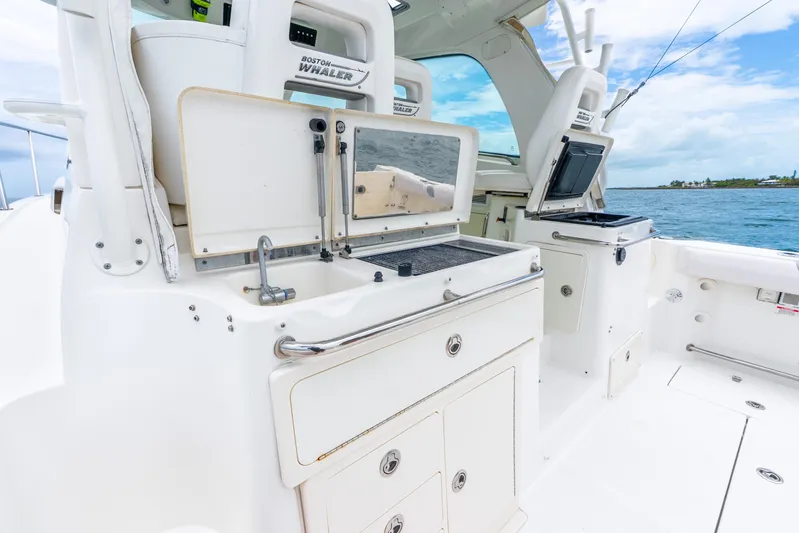 Reel Blessing Yacht Photos Pics 2012 Boston Whaler 345 Conquest boat interior with fishing station and ocean view.