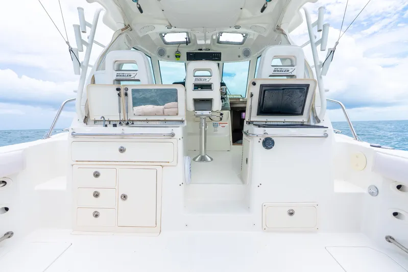 Reel Blessing Yacht Photos Pics 2012 Boston Whaler 345 Conquest boat interior with ocean view, featuring helm and seating area.