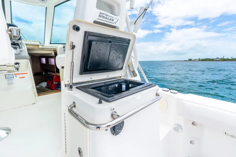 Reel Blessing Yacht Photos Pics 2012 Boston Whaler 345 Conquest boat interior with open storage compartment, ocean view.
