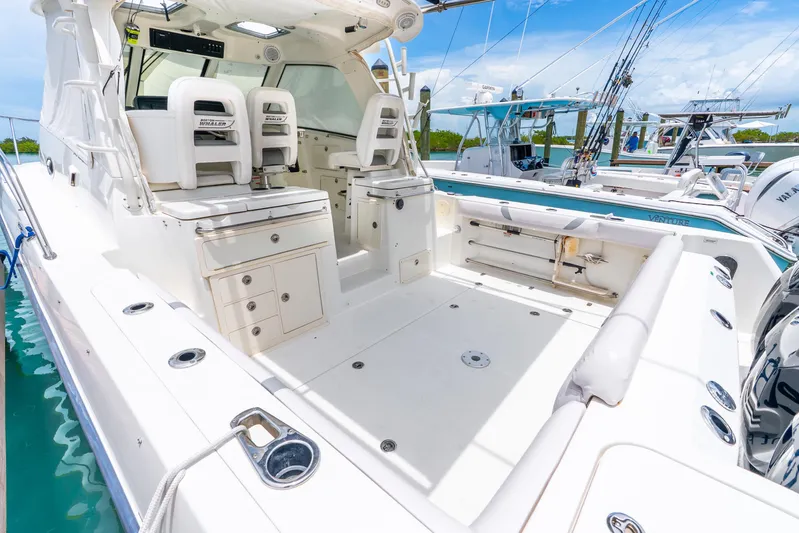 Reel Blessing Yacht Photos Pics 2012 Boston Whaler 345 Conquest boat interior with seating and storage, docked in a marina.