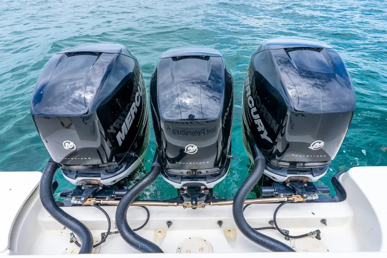 Reel Blessing Yacht Photos Pics Triple Mercury outboard engines on a 2012 Boston Whaler 345 Conquest in clear blue water.