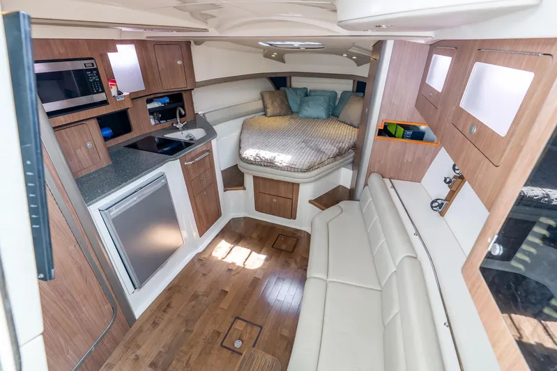 Reel Blessing Yacht Photos Pics Luxurious interior of 2012 Boston Whaler 345 Conquest with kitchenette and cozy sleeping area.