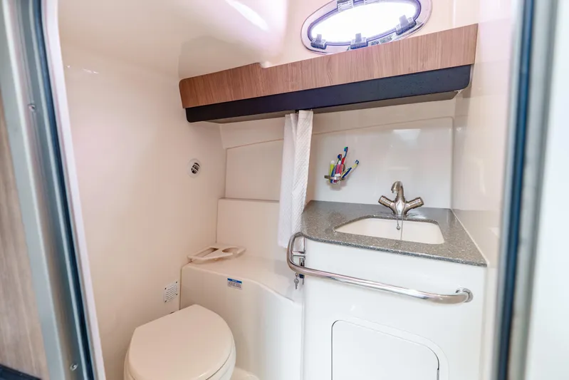 Reel Blessing Yacht Photos Pics 2012 Boston Whaler 345 Conquest bathroom with sink, toilet, and storage.