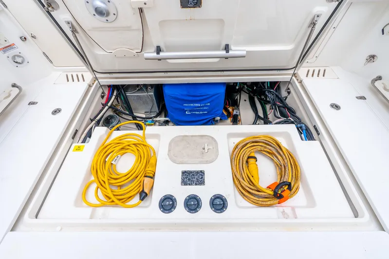 Reel Blessing Yacht Photos Pics 2012 Boston Whaler 345 Conquest engine compartment with cables and equipment.