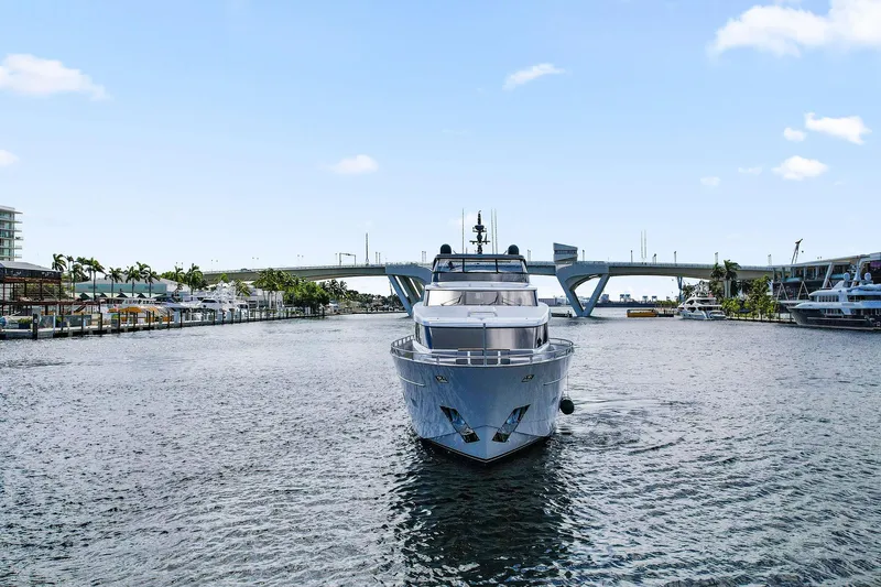Notorious Yacht Photos Pics Sanlorenzo SL106 yacht from 2017 cruising under a bridge on a sunny day.