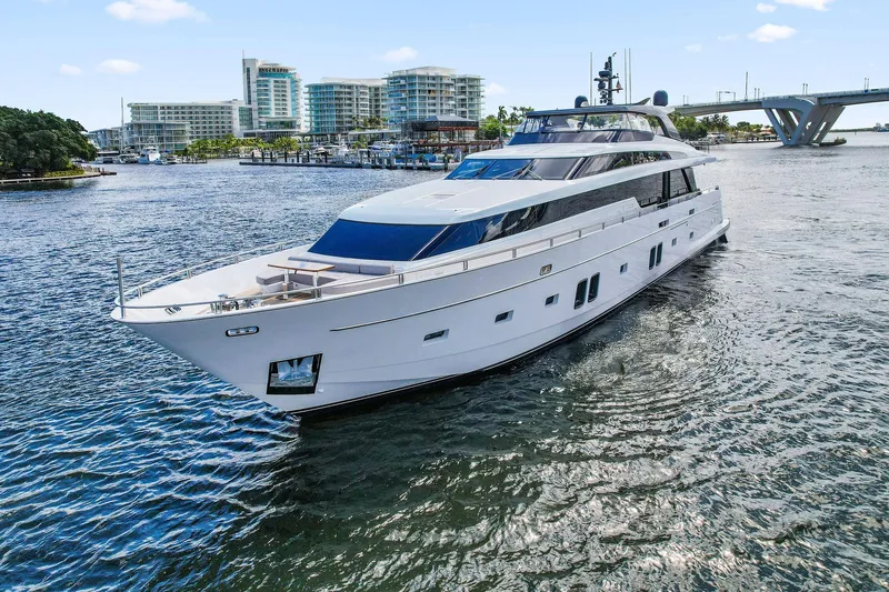 Notorious Yacht Photos Pics Luxurious 2017 Sanlorenzo SL106 yacht cruising near modern waterfront buildings.