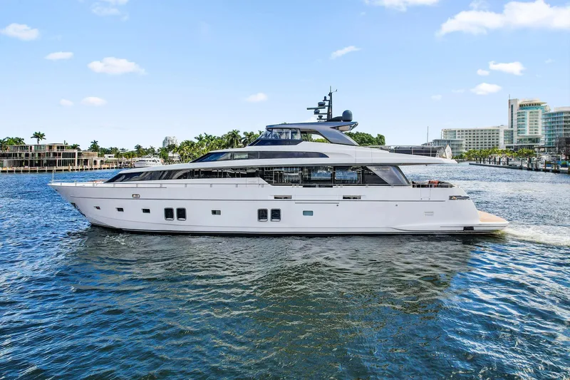 Notorious Yacht Photos Pics Luxury 2017 Sanlorenzo SL106 yacht cruising on a sunny day near a coastal city.