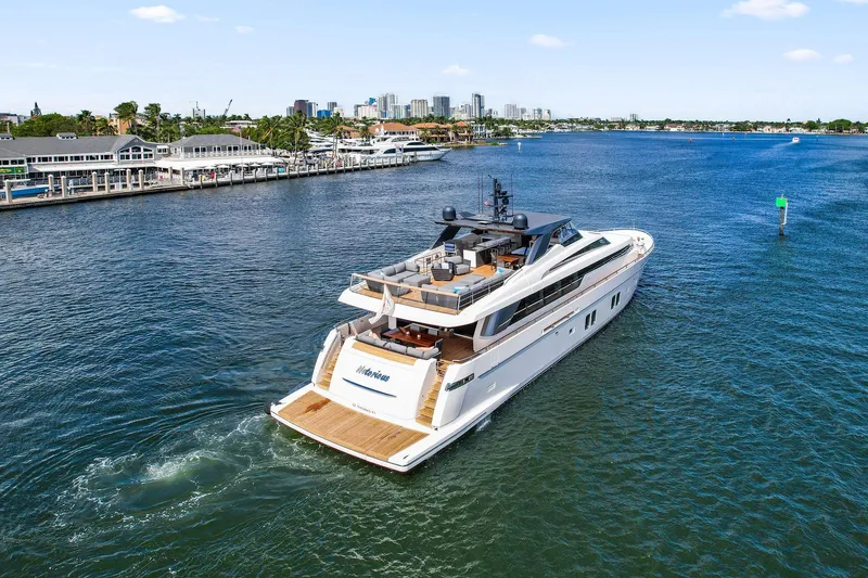 Notorious Yacht Photos Pics Luxurious 2017 Sanlorenzo SL106 yacht cruising near a marina with city skyline.