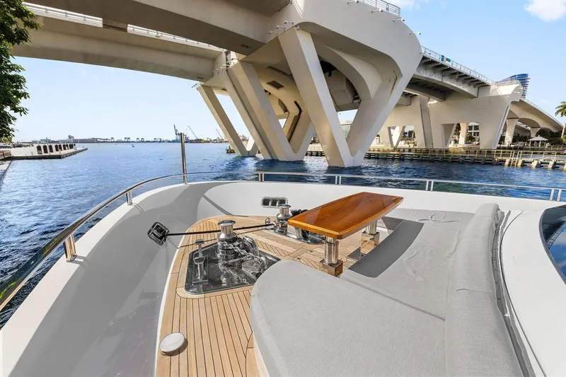 Notorious Yacht Photos Pics Sanlorenzo SL106 yacht deck with wooden table, under a modern bridge, 2017 model.