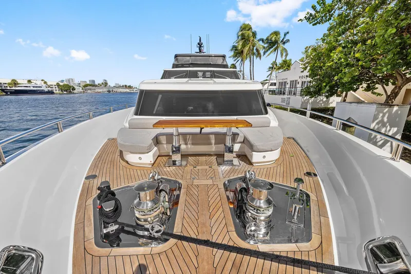 Notorious Yacht Photos Pics Luxurious 2017 Sanlorenzo SL106 yacht deck with seating and winches, docked by palm trees.