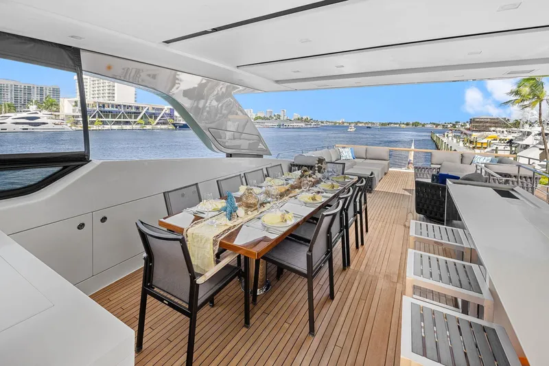 Notorious Yacht Photos Pics Luxurious 2017 Sanlorenzo SL106 yacht with elegant outdoor dining area and scenic waterfront view.