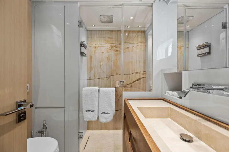 Notorious Yacht Photos Pics Luxurious bathroom in 2017 Sanlorenzo SL106 yacht with marble accents and modern fixtures.