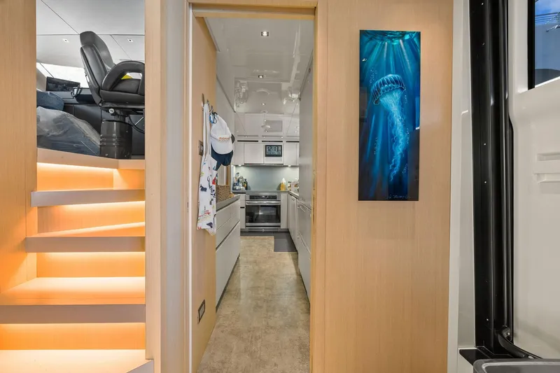 Notorious Yacht Photos Pics Interior of 2017 Sanlorenzo SL106 yacht with modern kitchen and illuminated staircase.