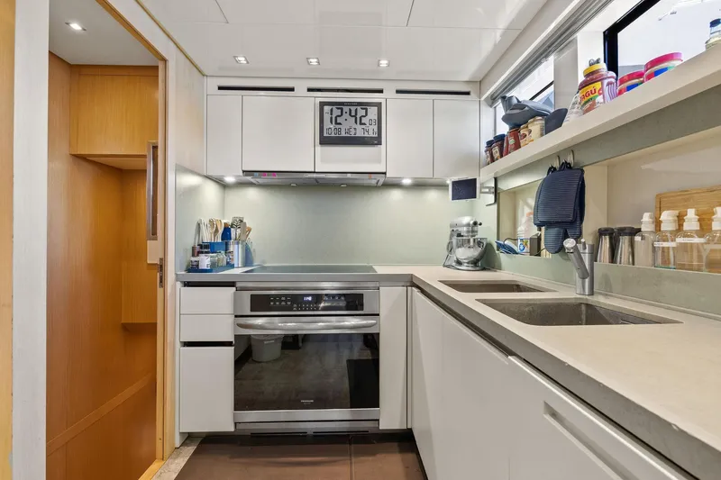 Notorious Yacht Photos Pics Modern kitchen interior on 2017 Sanlorenzo SL106 yacht, featuring sleek cabinetry and appliances.