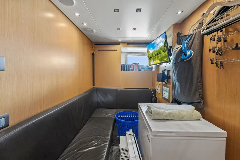 Notorious Yacht Photos Pics 2017 Sanlorenzo SL106 yacht interior with cozy seating, TV, and storage space.