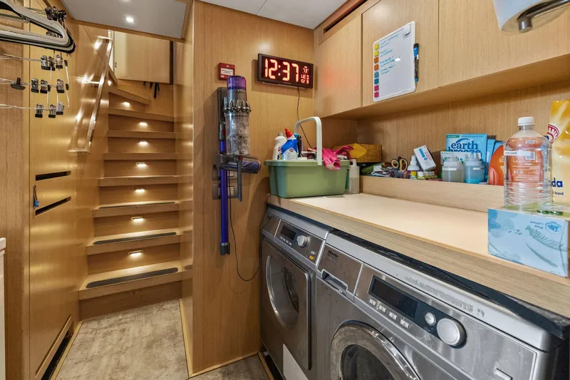 Notorious Yacht Photos Pics Laundry area on 2017 Sanlorenzo SL106 yacht with stairs and storage shelves.