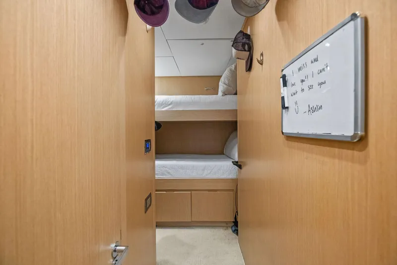 Notorious Yacht Photos Pics 2017 Sanlorenzo SL106 yacht cabin with bunk beds and a whiteboard message.