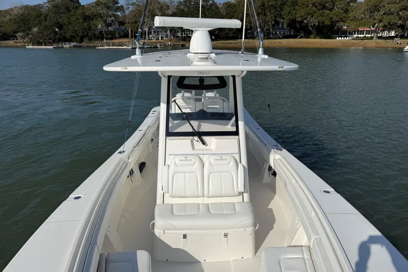  Yacht Photos Pics 2020 Regulator 31 boat on calm water, featuring sleek design and spacious seating.
