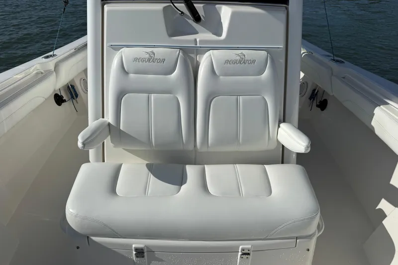  Yacht Photos Pics 2020 Regulator 31 boat with white cushioned seating and armrests on deck.