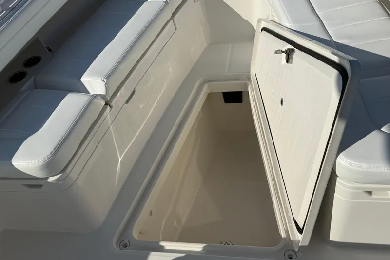  Yacht Photos Pics 2020 Regulator 31 boat with open storage compartment and cushioned seating.