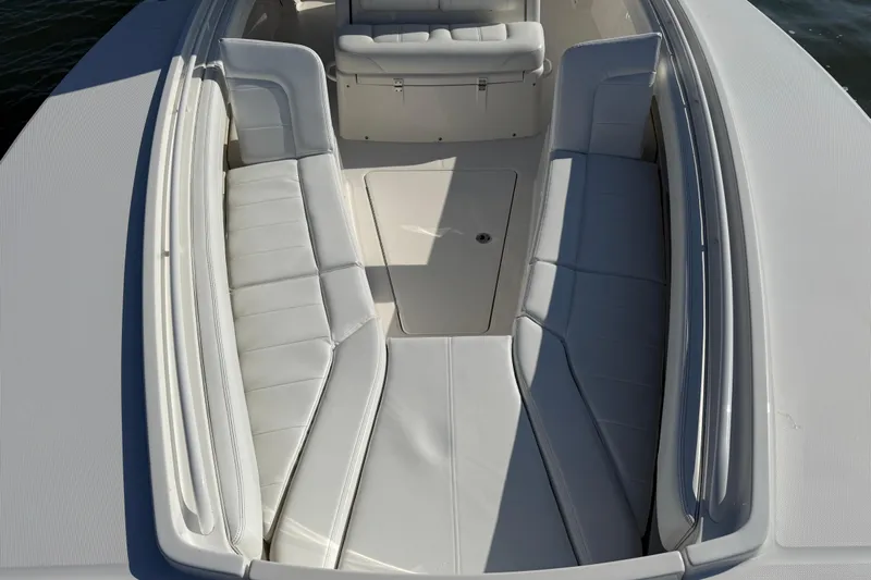  Yacht Photos Pics 2020 Regulator 31 boat interior with white cushioned seating and storage compartment.