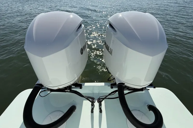  Yacht Photos Pics Twin outboard motors on a 2020 Regulator 31 boat, glistening on the water.