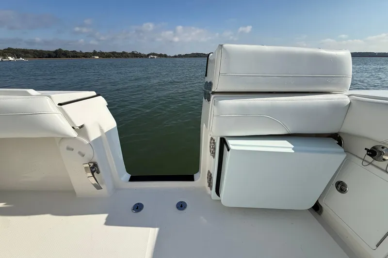  Yacht Photos Pics 2020 Regulator 31 boat interior with white seating, overlooking calm waters.