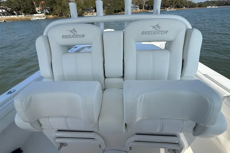  Yacht Photos Pics 2020 Regulator 31 boat with white cushioned seats on a calm water backdrop.