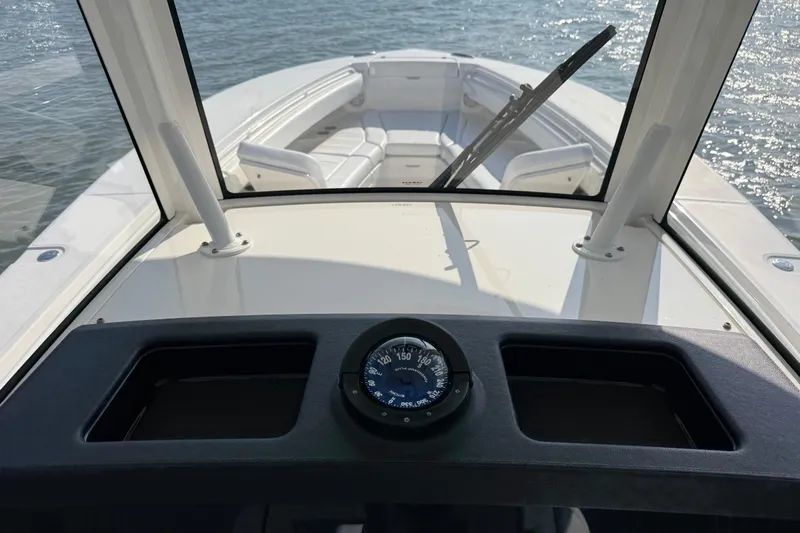  Yacht Photos Pics 2020 Regulator 31 boat interior with compass, windshield, and seating on water.
